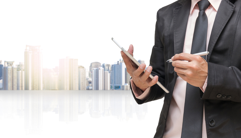 Businessman-using-the-tablet-on-cityscape-blurred-background_Business-concept-815420244_784x450.jpeg