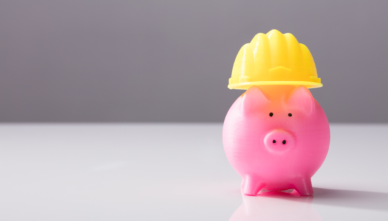Close-up-Of-A-Piggy-Bank-With-Hard-Hat-949208366_1360x774.jpeg