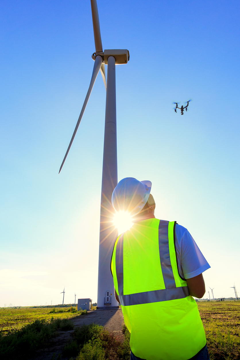 Drone-Pilot-Operating-UAV-During-Wind-Turbine-Inspection-878674616_839x1258.jpeg