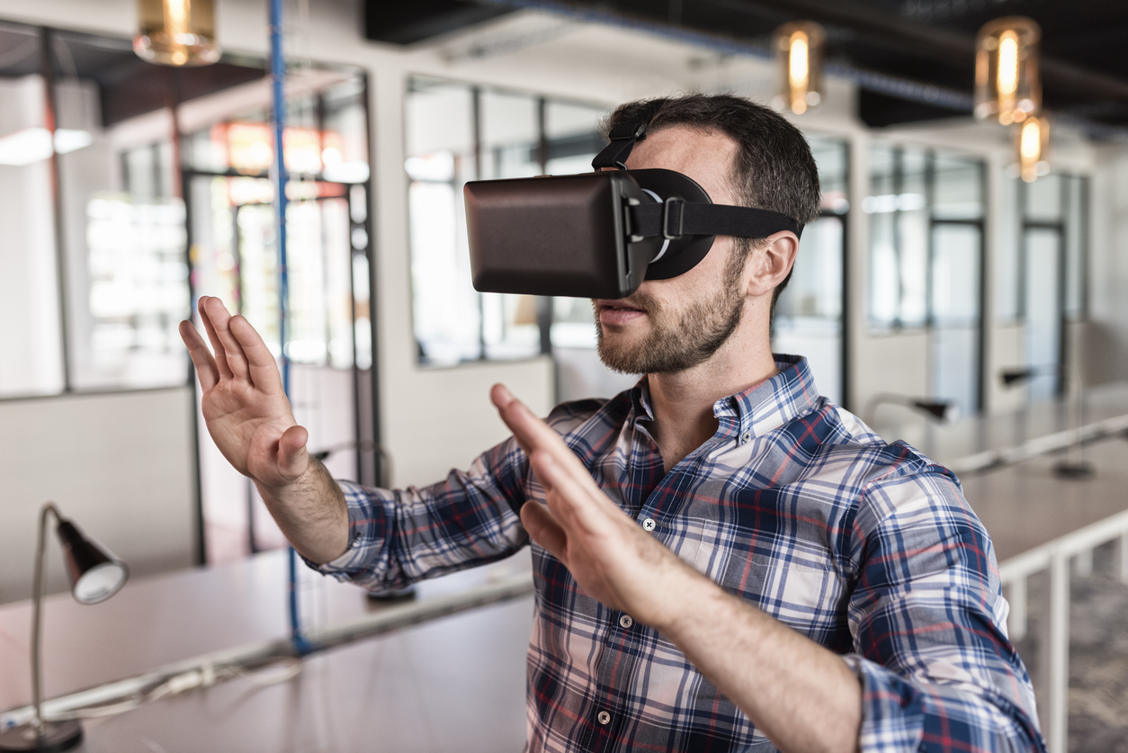 Man-using-virtual-reality-glasses-in-startup-office_-622206374_1256x838.jpeg