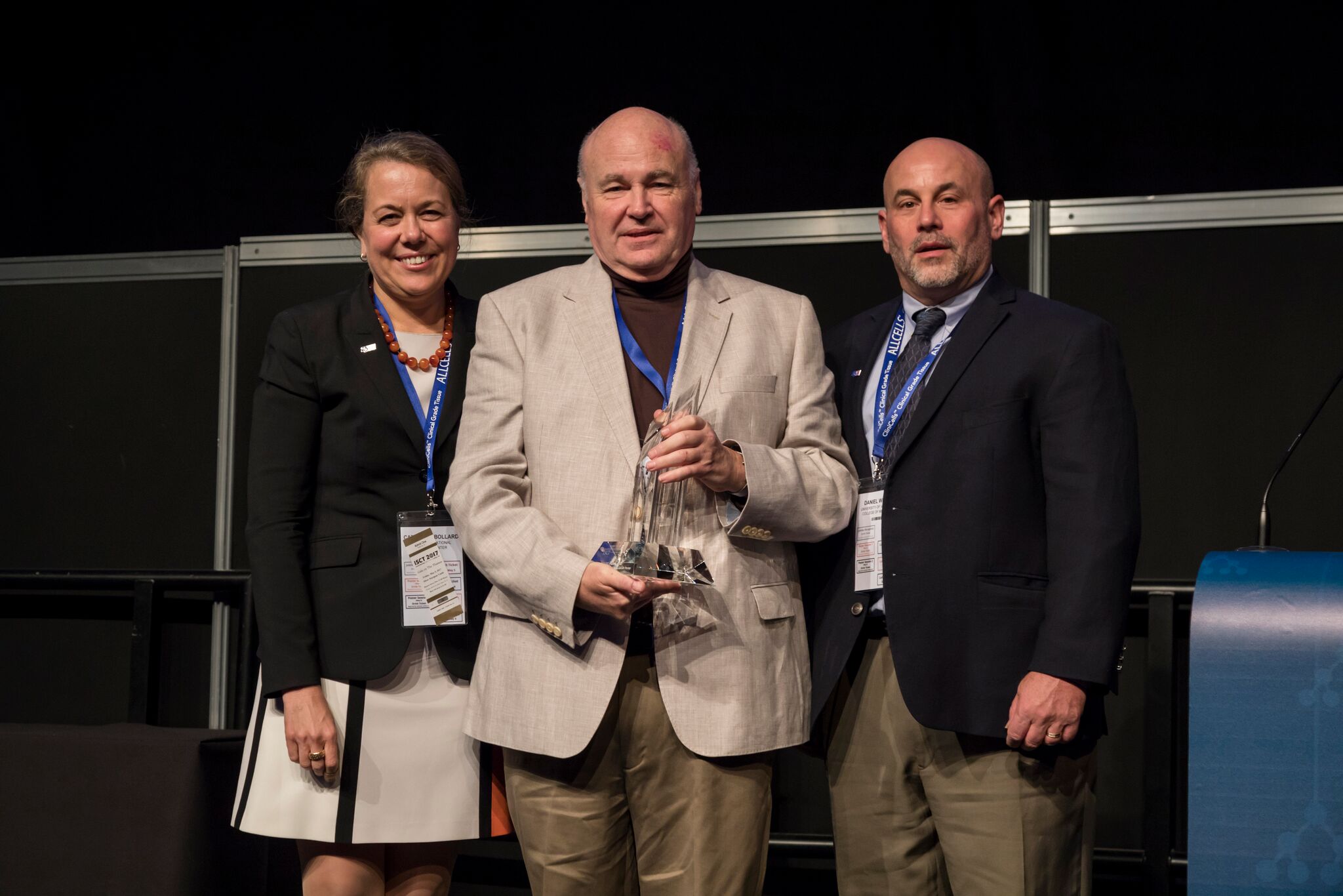 Adrian Gee receiving award with colleagues