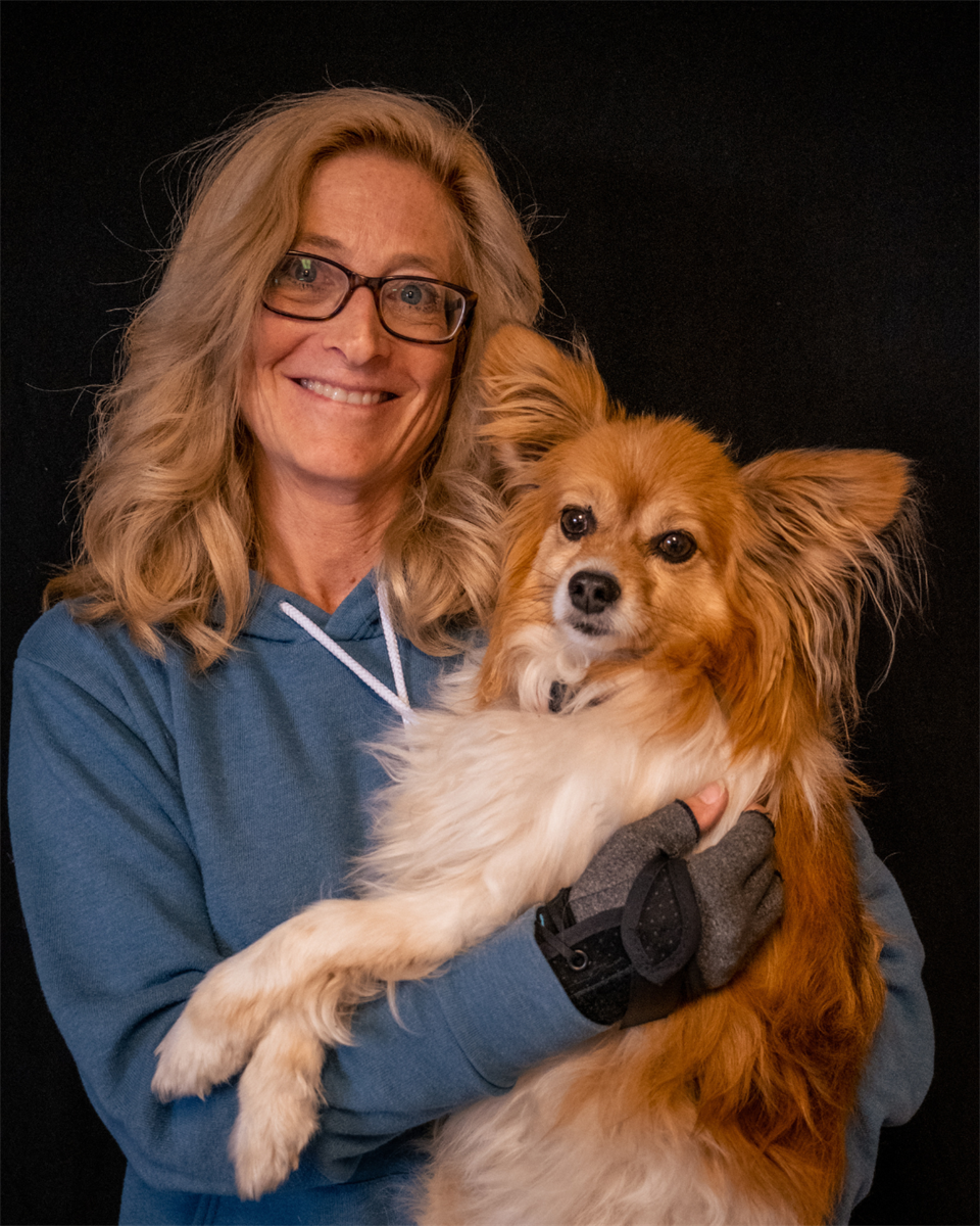 Marta holding her orange and white dog