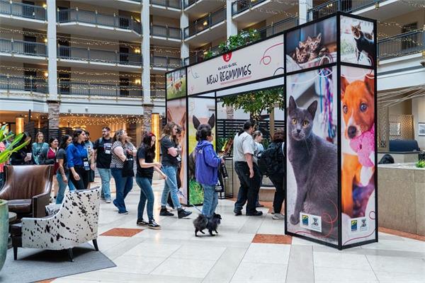 A photo of the arch at Texas Unites for Animals, with attendees walking the halls.