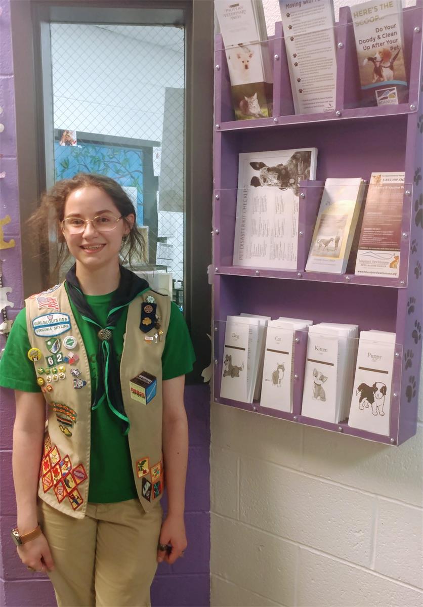 girl scout with brochure rack