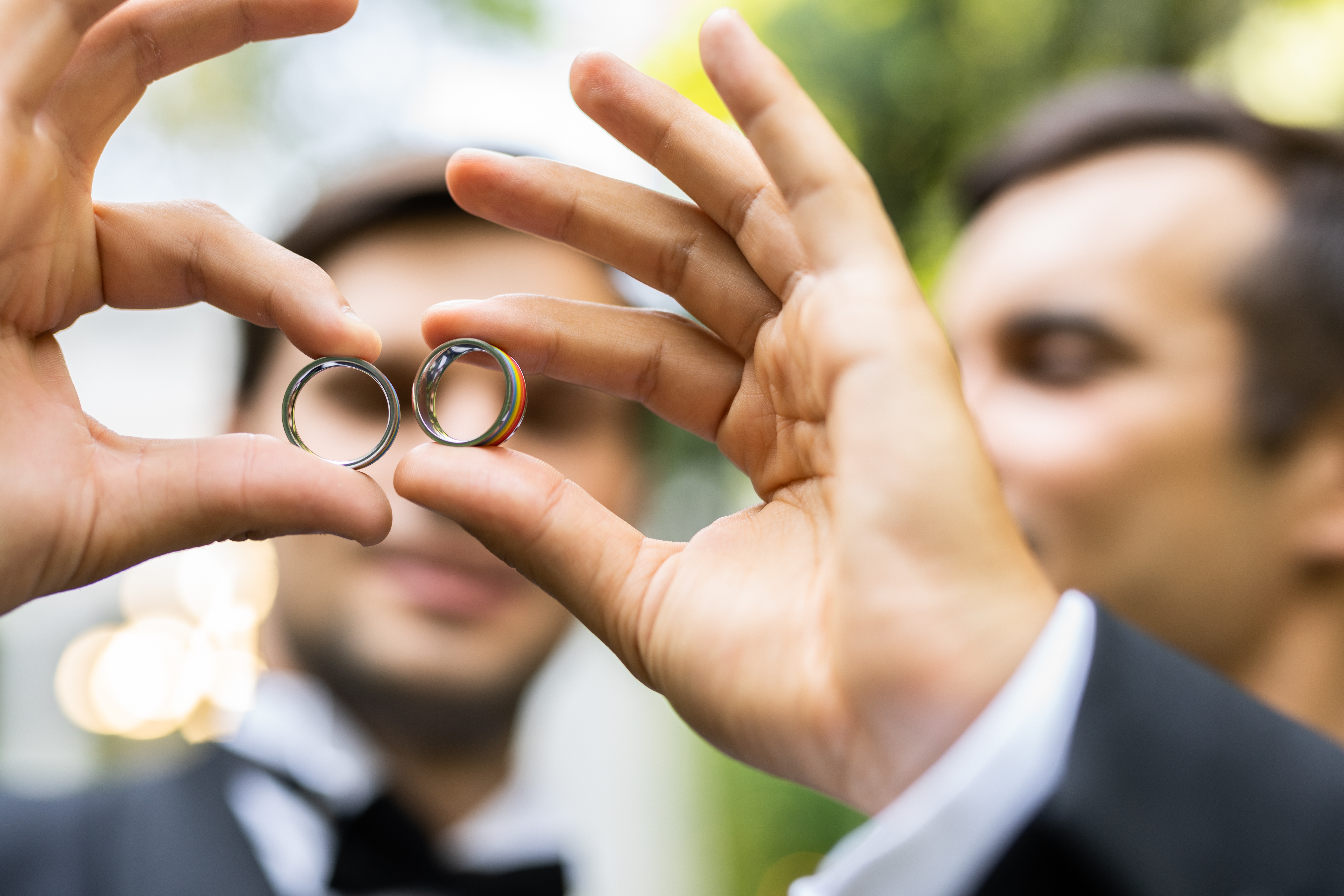 Individual looking straight into the camera with a distressed pose as both hands grasp the head