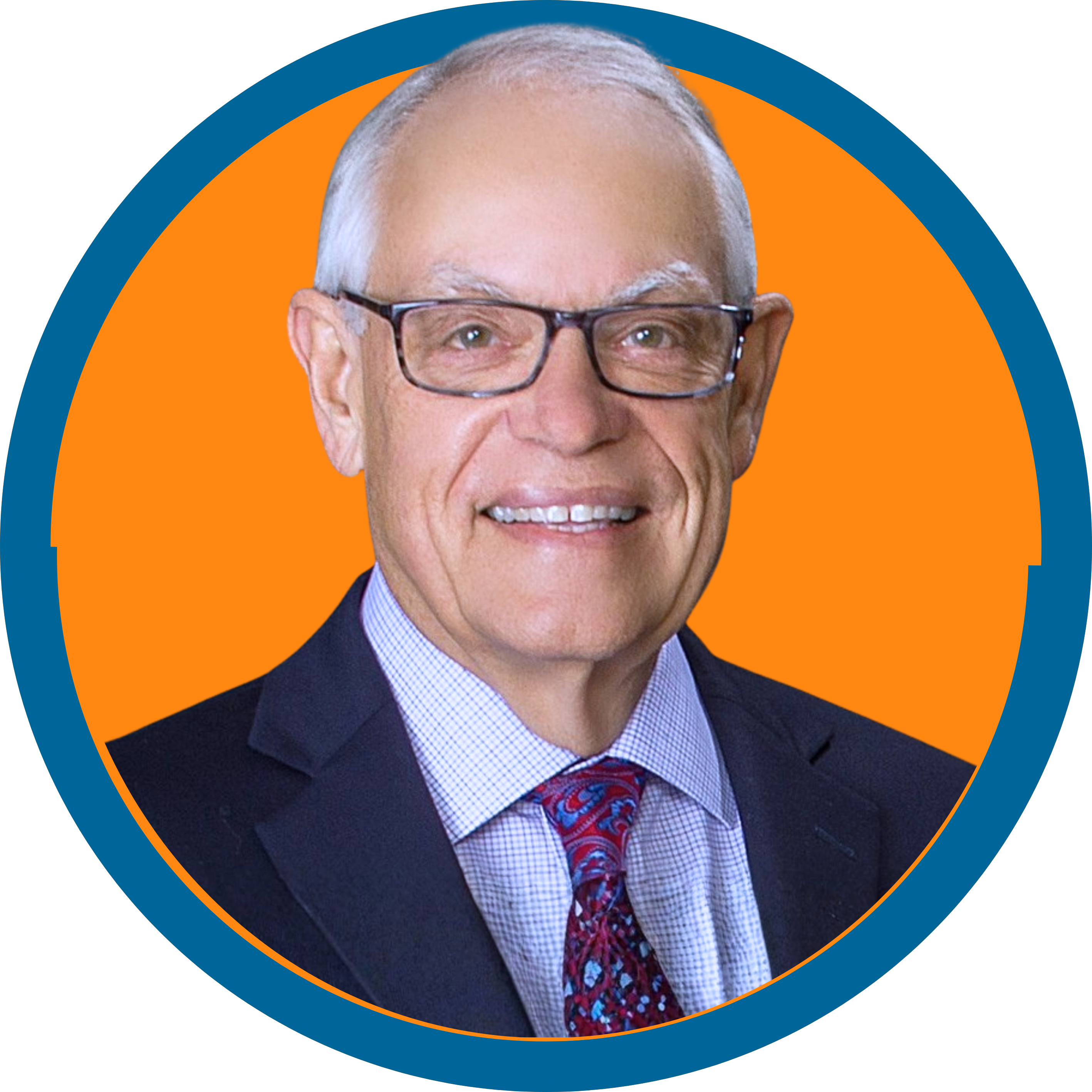 Image of a white man with white hair and black glasses in a navy suit