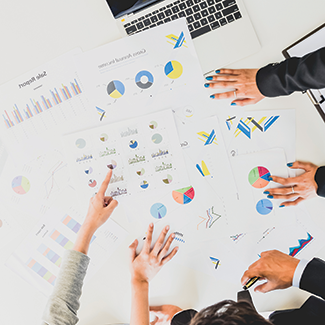 image of people reviewing documents in a meeting
