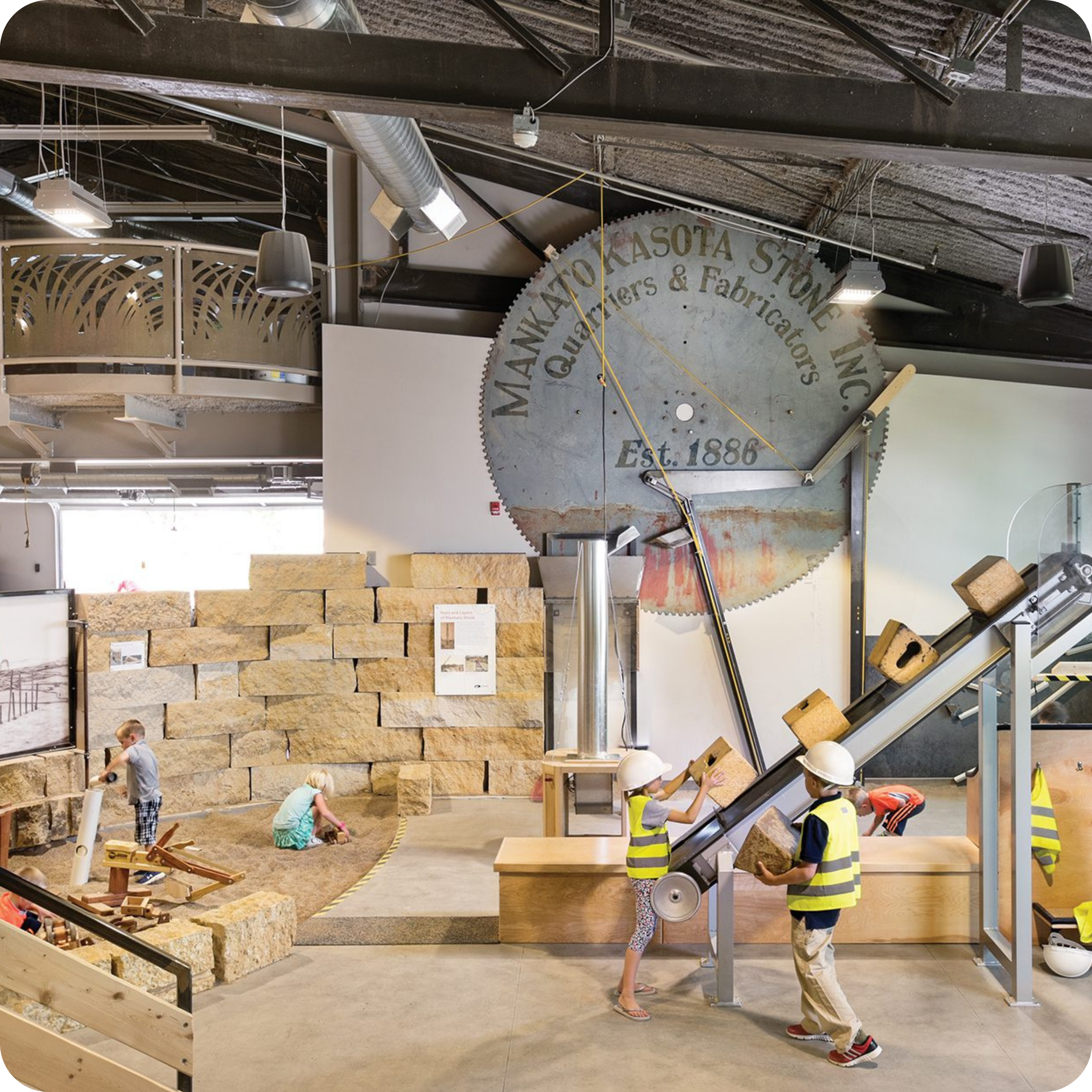 An indoor exhibit featuring a large circular saw with 