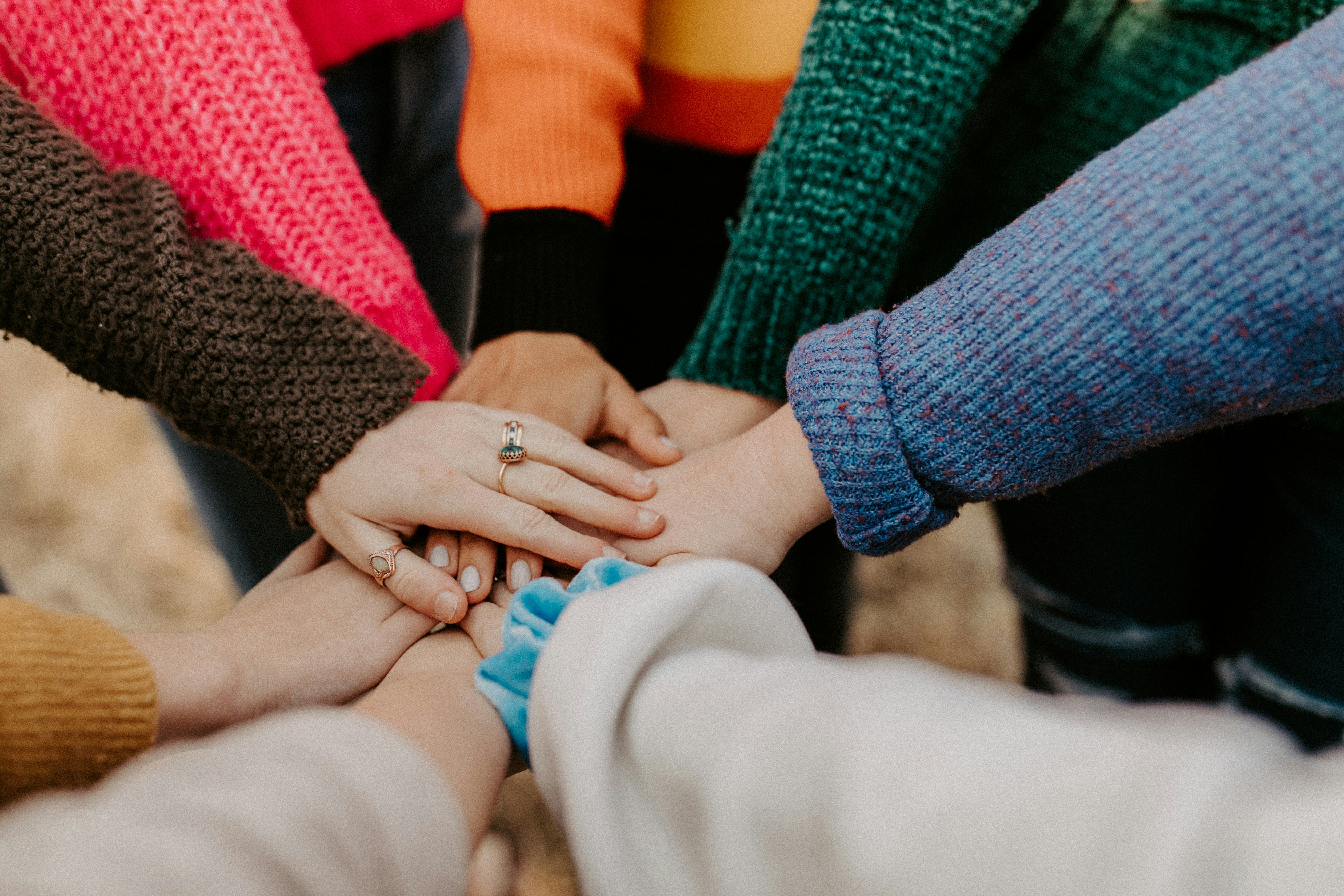 Colleagues placing their hands together