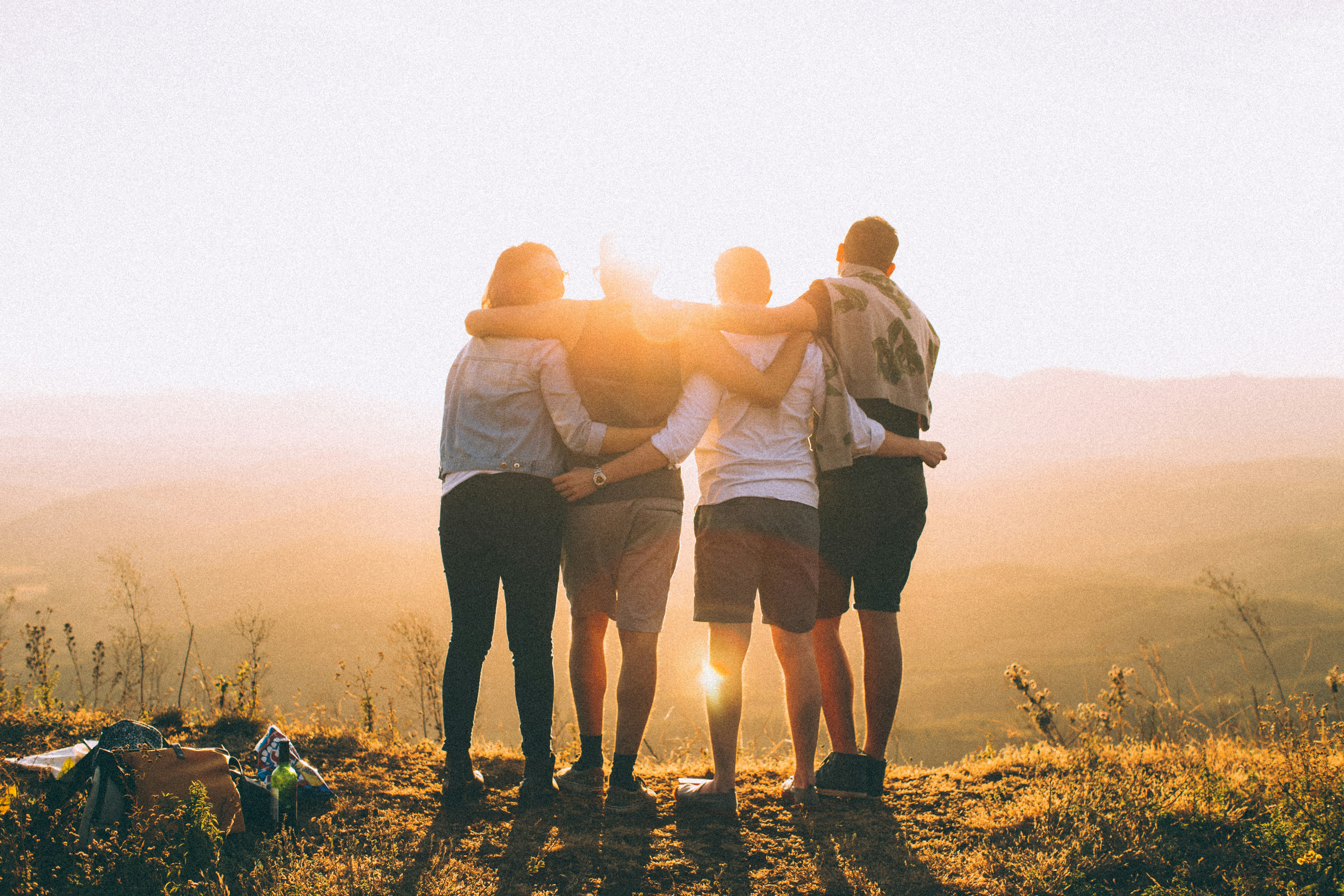 Group of colleagues standing together at sunset