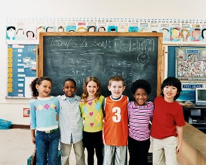 Kids in front of a chalkboard