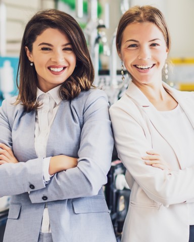 Two confident women smiling at camera