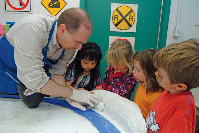 Rich Virgin working with children on model railroad