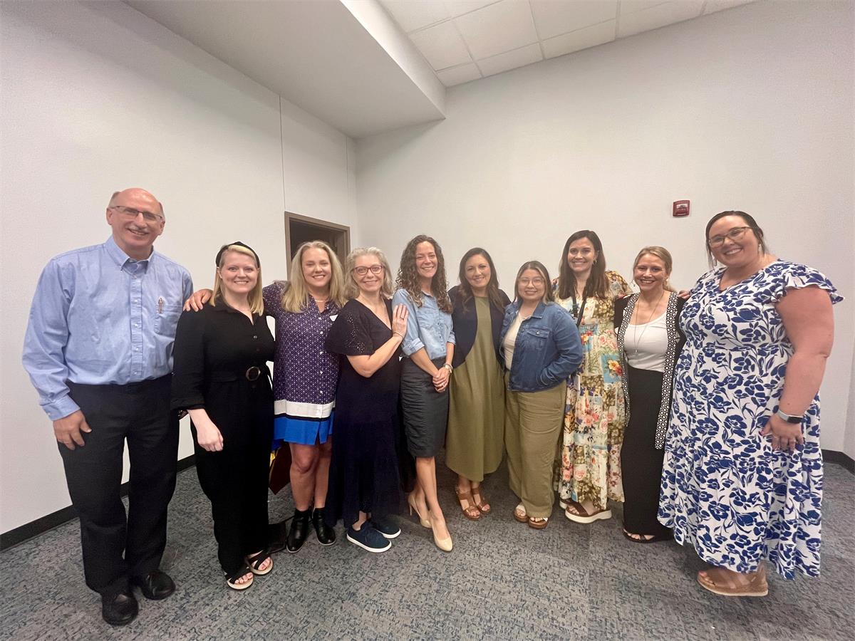 NCSBY Administrator Trish with black dress standing next to various Lena Pope team members 
