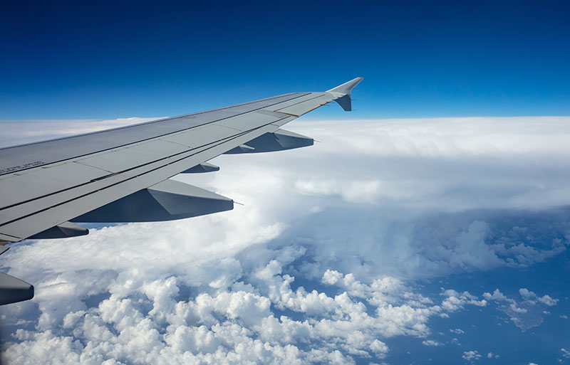 plane-wing-on-blue-sky-background-GP8X4NM.jpg