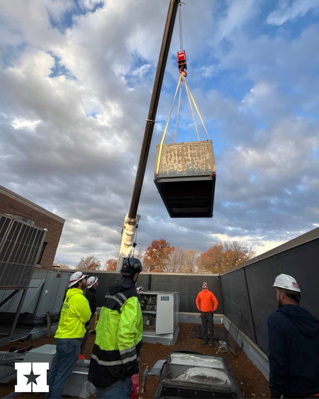 Workers look up at a crane in East St. Louis