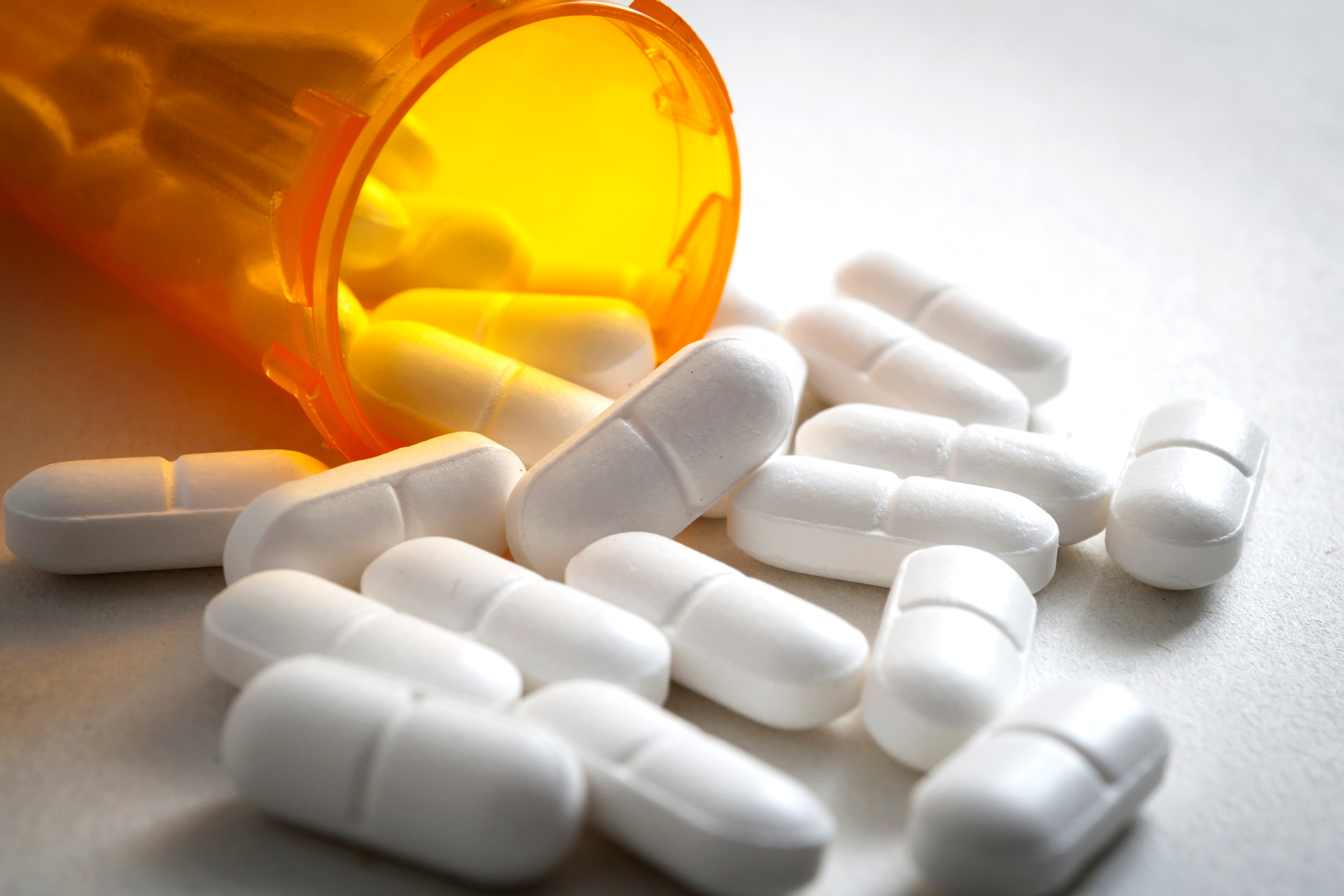 A collection of pills that have tumbled out of a pill bottle