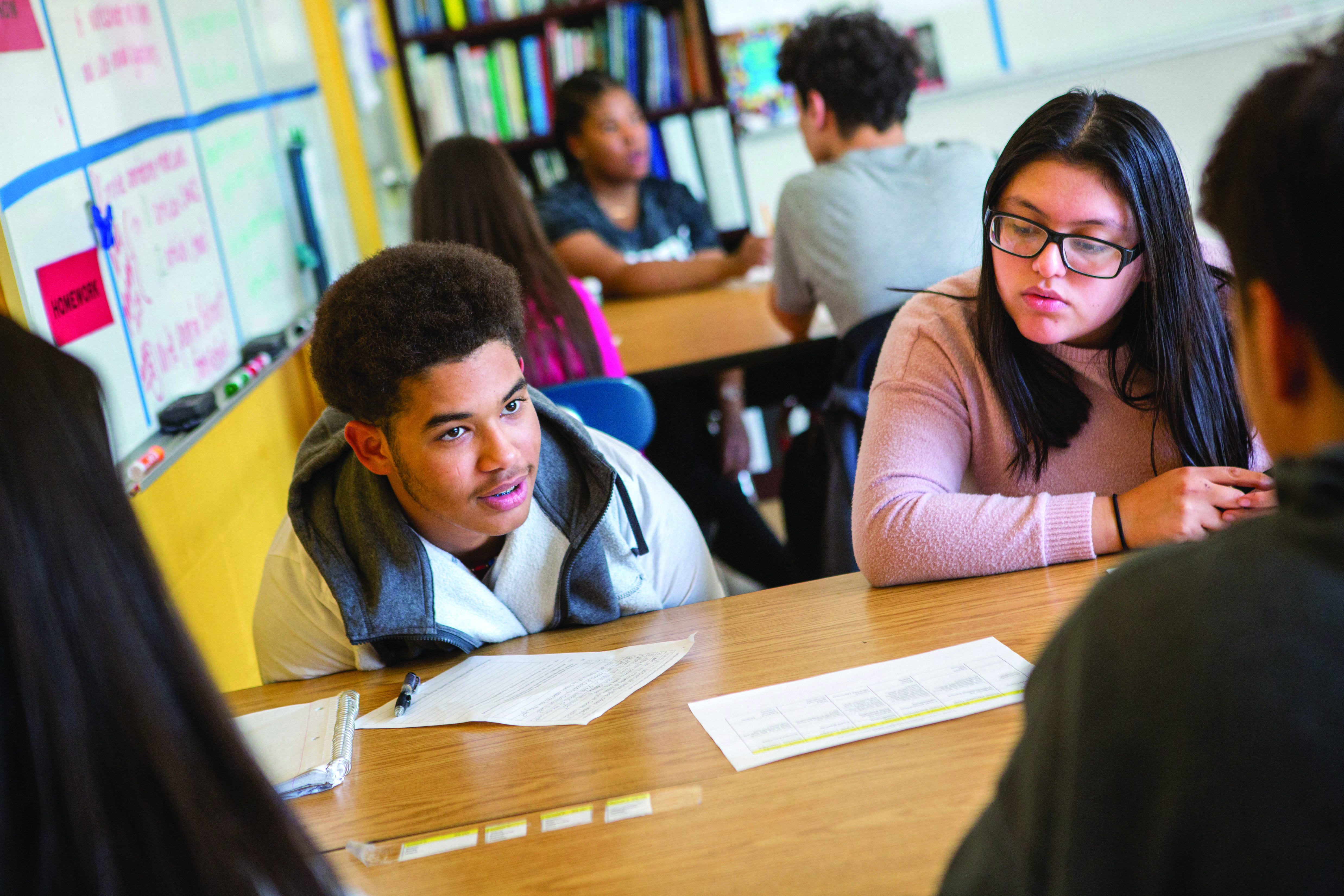 Students engaged in a discussion at a classroom table