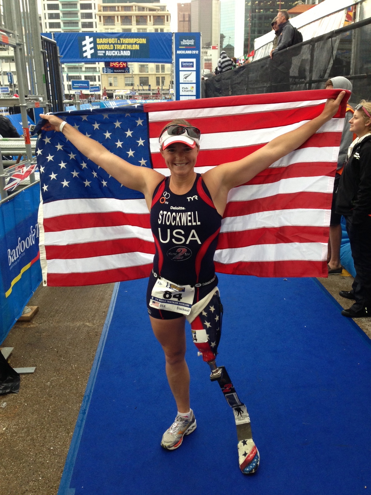 Melissa Stockwell poses with an American flag behind her at the Paralympics