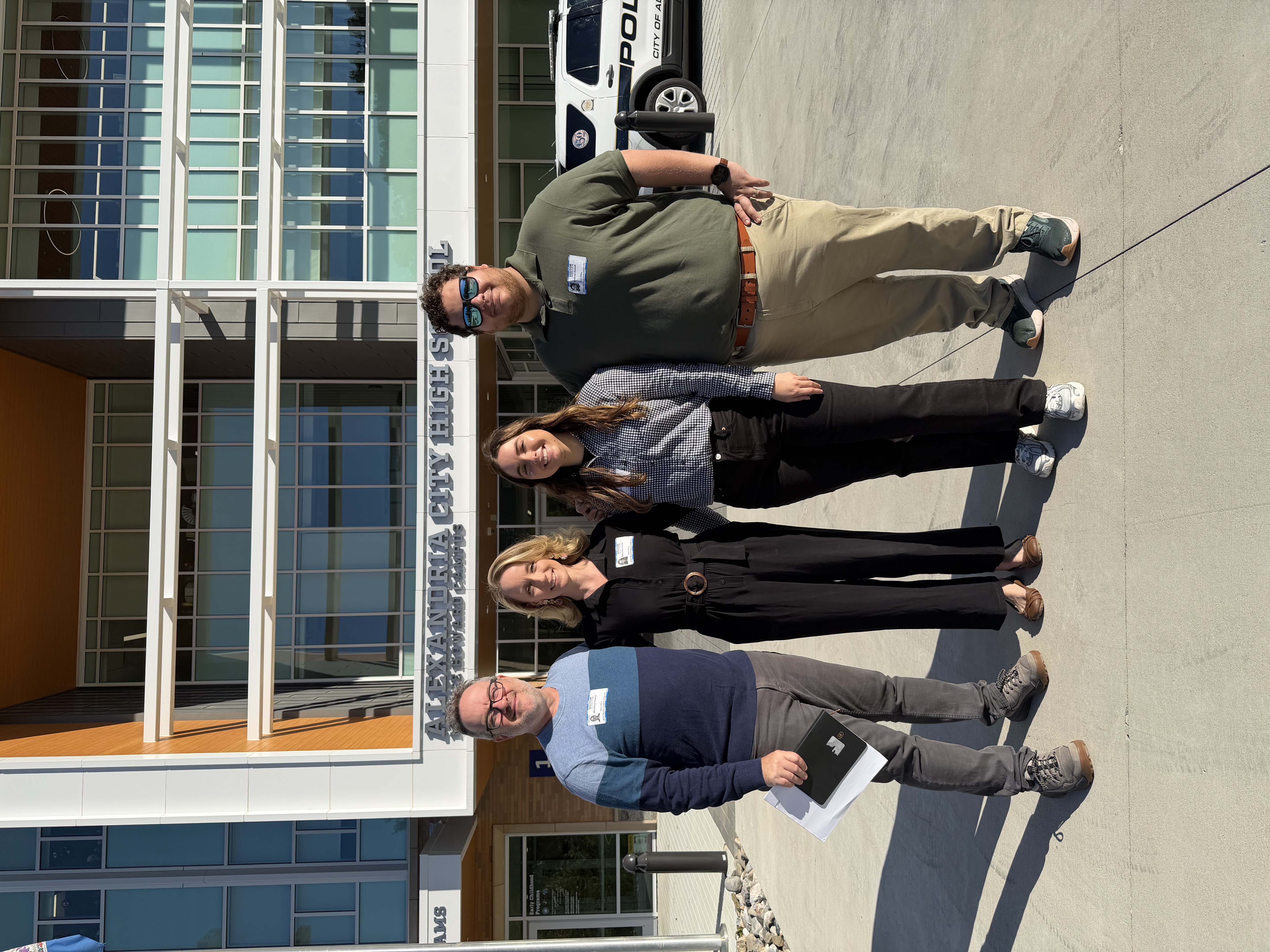 Individuals standing in front of Alexandria City High School