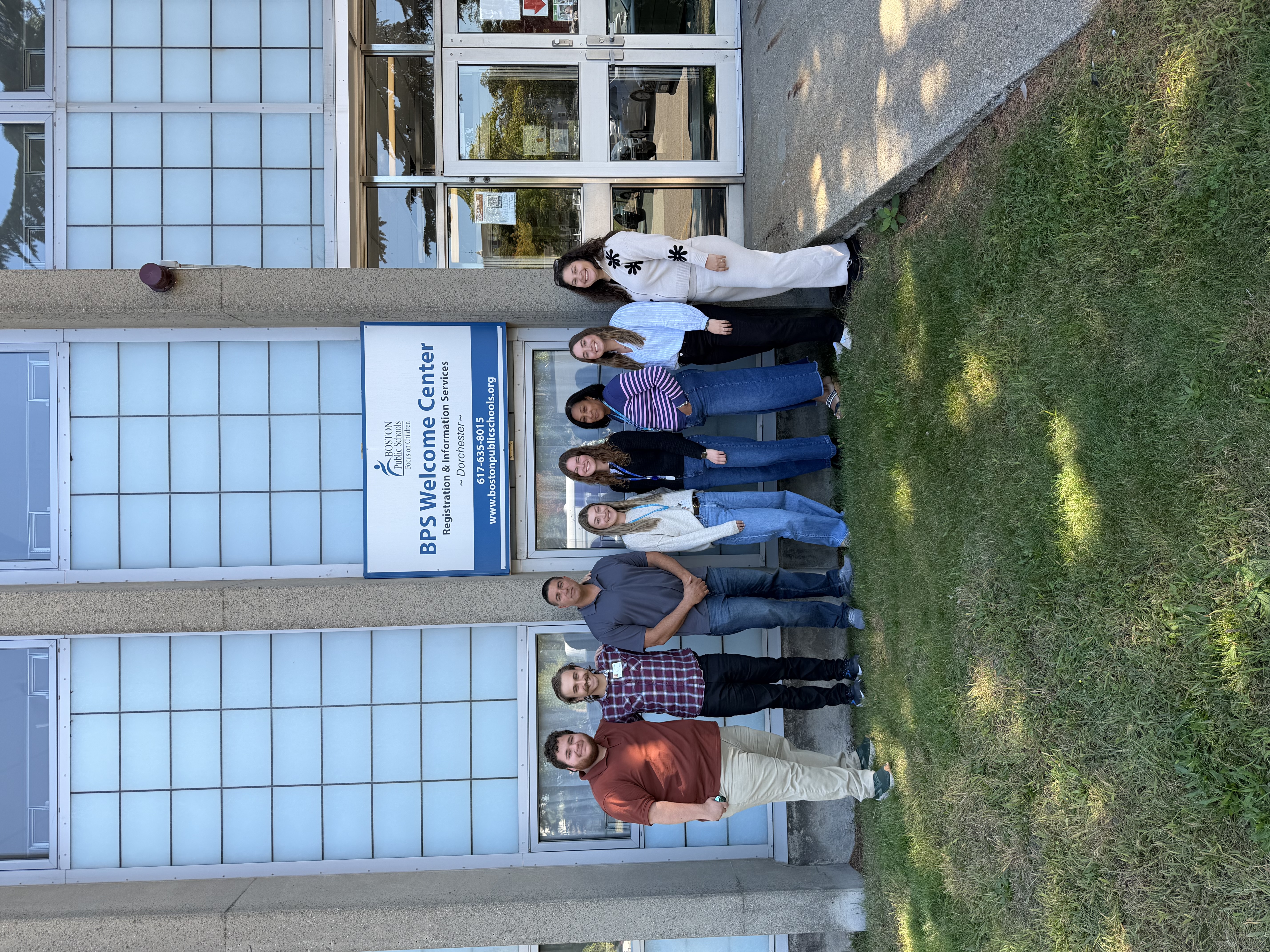 Individuals standing in front of the Boston Public Schools Welcome Center