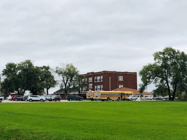 A far away view of a school building in a rural area