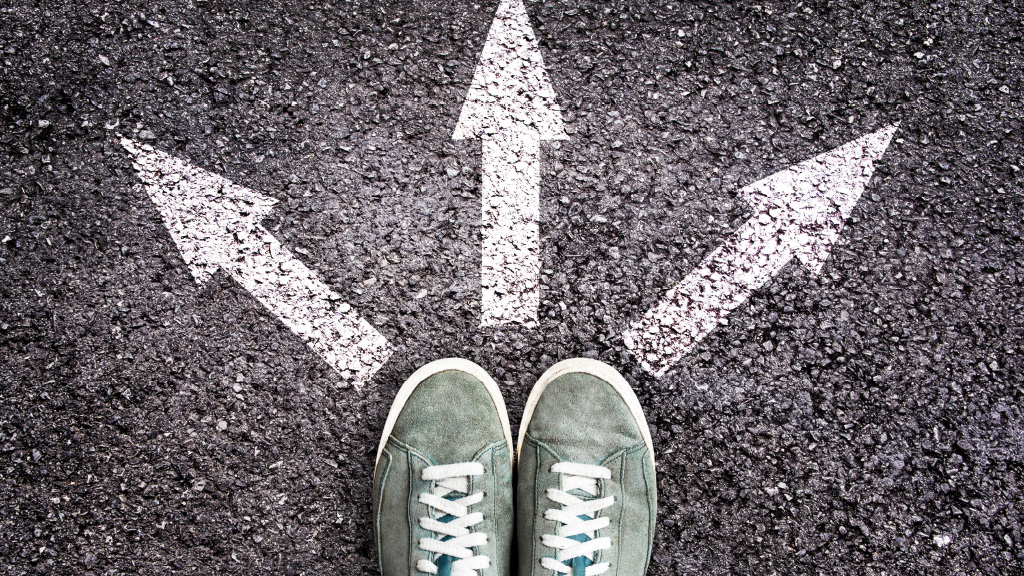 Shoes positioned at the bottom of three arrows pointing in different directions