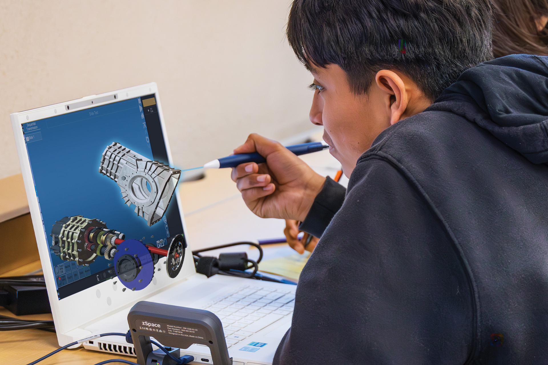A boy explores a car engine using an augmented and virtual reality learning platform.