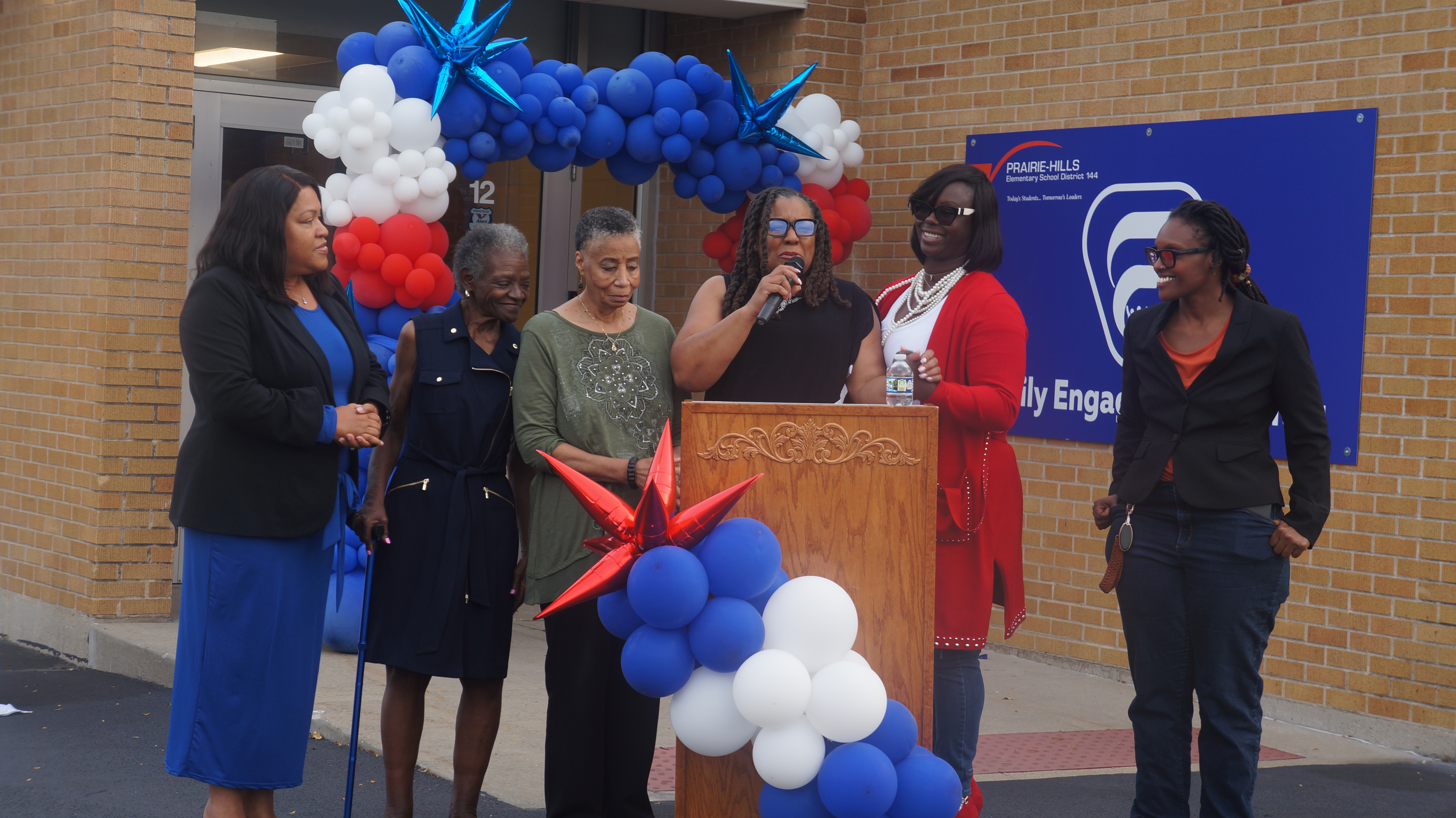 A group of school leaders celebrate the grand opening of the district's new community center. 