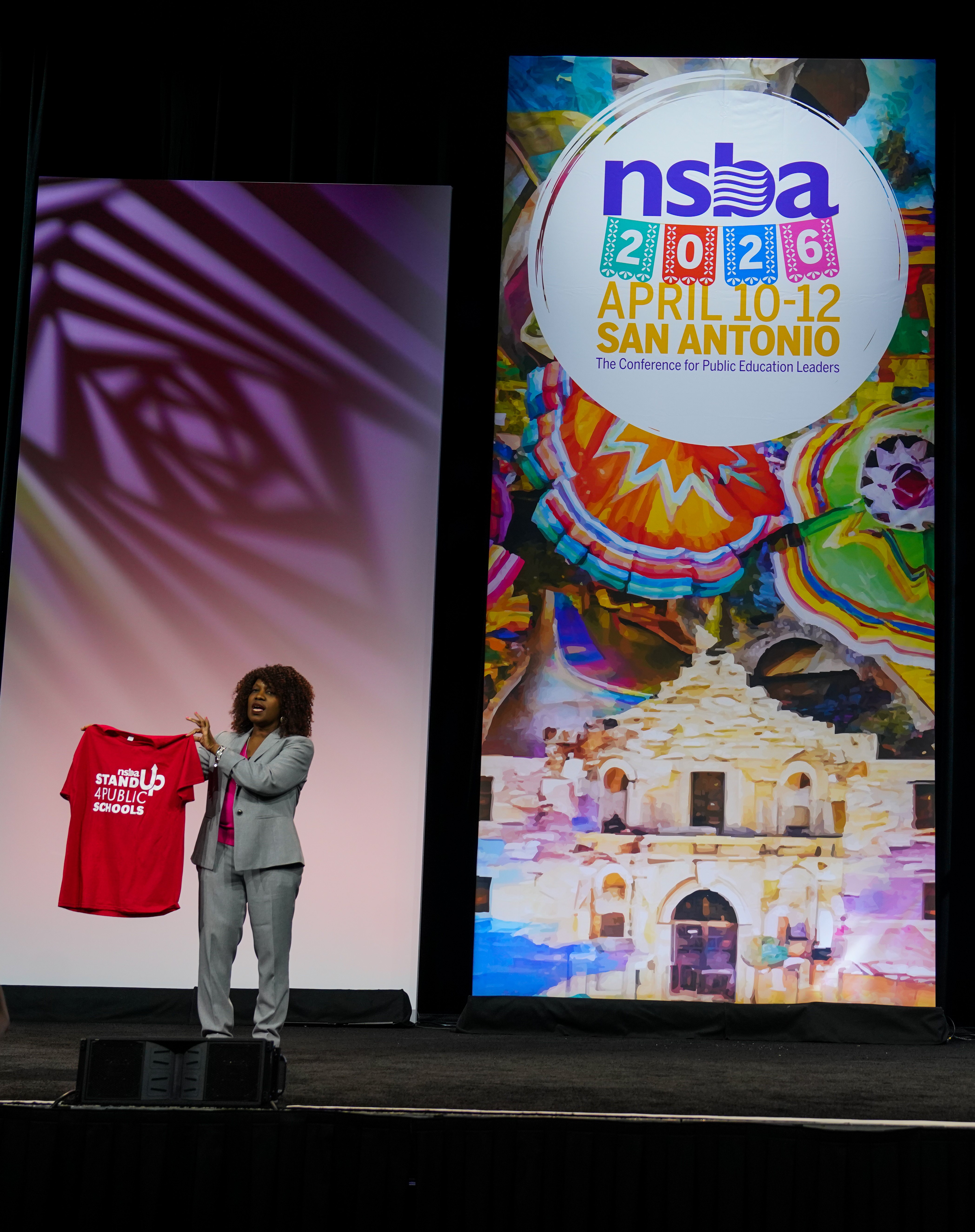 NSBA Executive Director and CEO Verjeana McCotter-Jacobs holds a "Stand Up 4 Public School" t-shirt during NSBA's 2026 Annual Conference