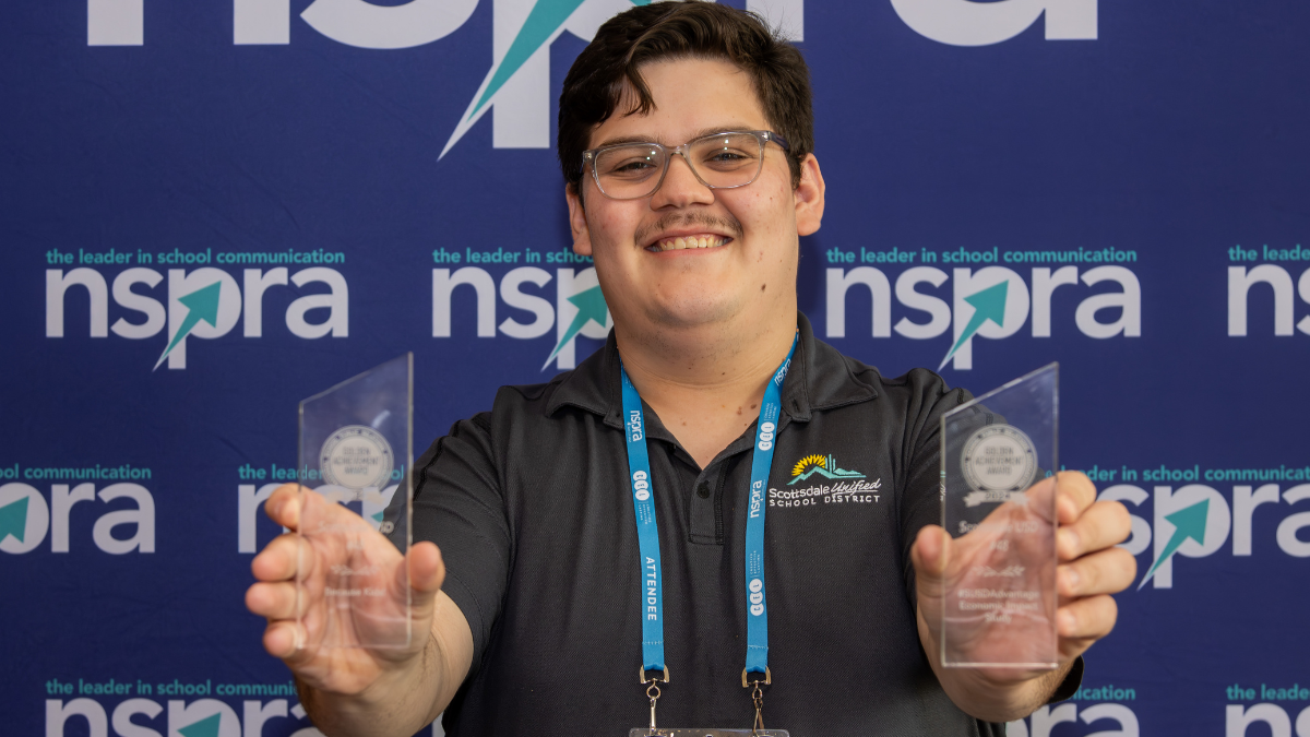 NSPRA MEMBER HOLDING AWARDS SMILING