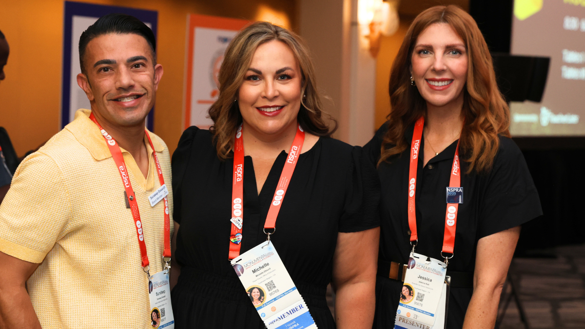 THREE NSPRA MEMBERS SMILING AT CAMERA