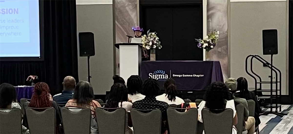 Induction Ceremony Dr. Lisa Kreeger purple cowboy hat.