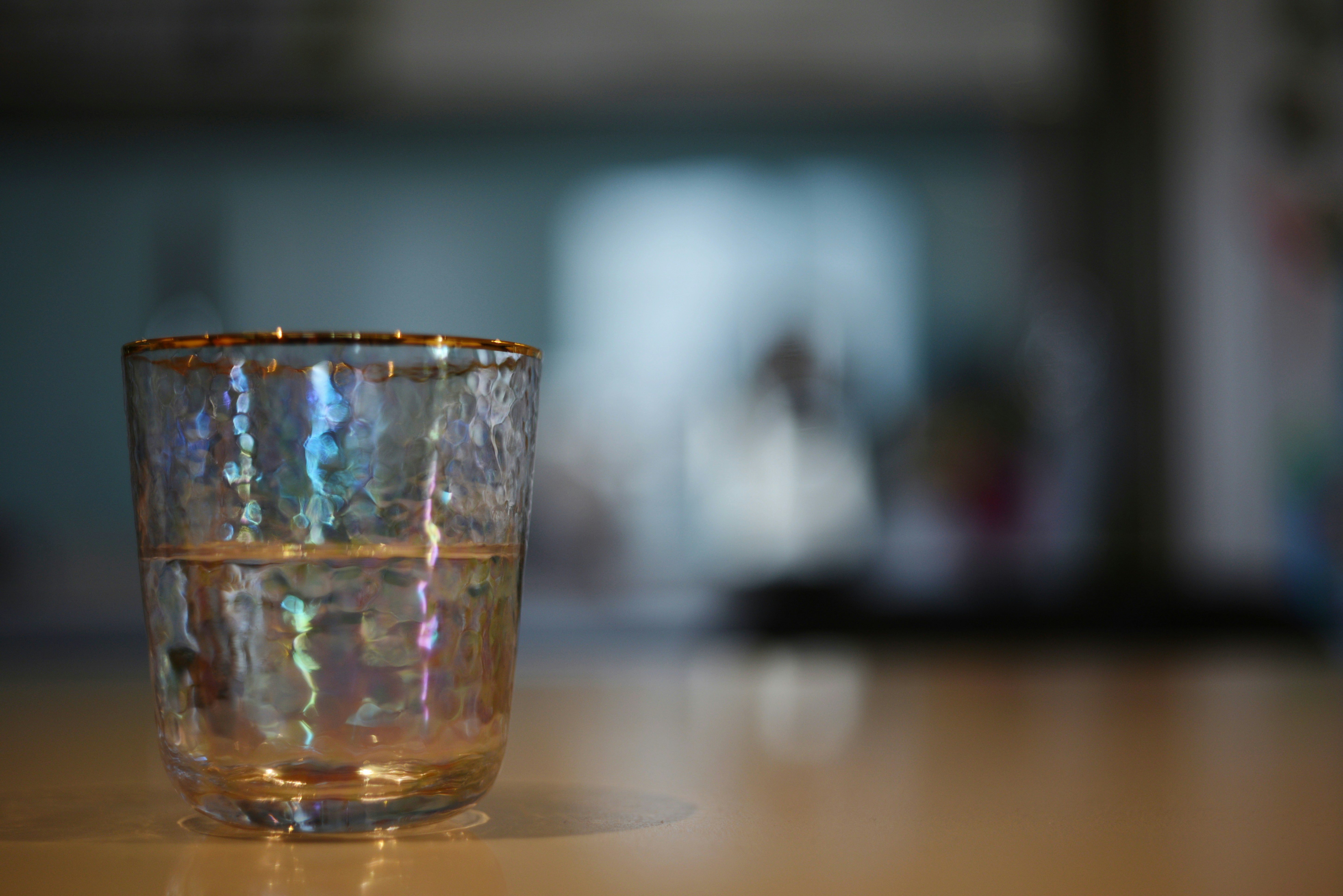 Glass on a table, half full