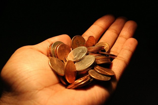 coins in the palm of a hand