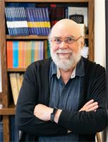 Steve Ruggles leaning casually in a library