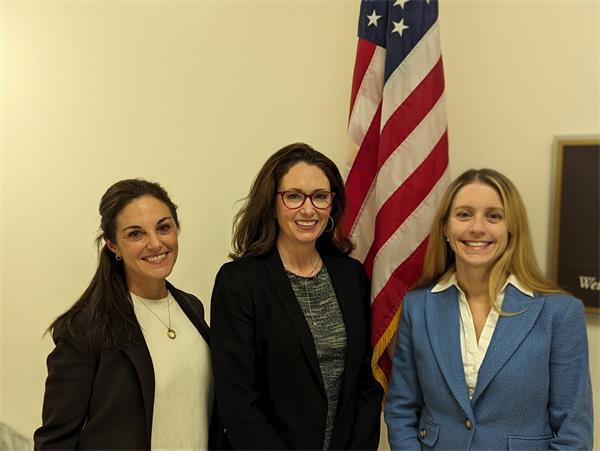 Kearney, Sciubba, Guzzo Panelists Kearney, Sciubba, Guzzo pose in front of American flag in the Rayburn building