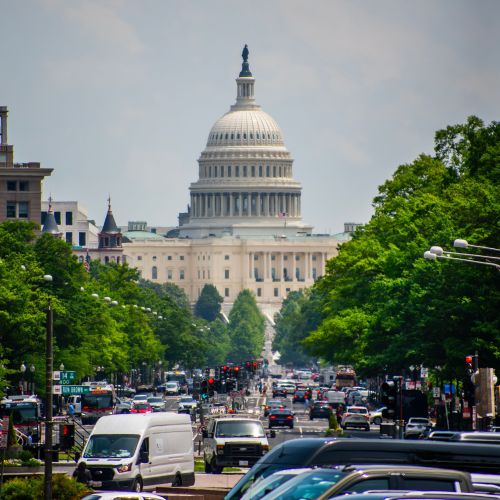 Capitol Building down a Washington DC busy road Capitol Building down a Washington DC busy road
