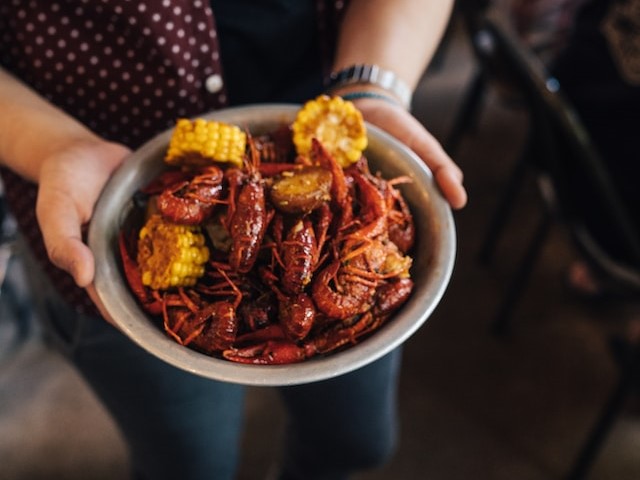 Person holding crawfish bowl
