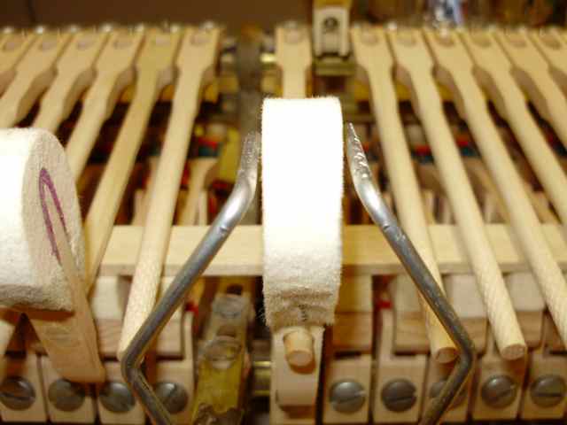 Center the shank between the wires (moving the jig), then lower the hammer and center the crown between the wires.