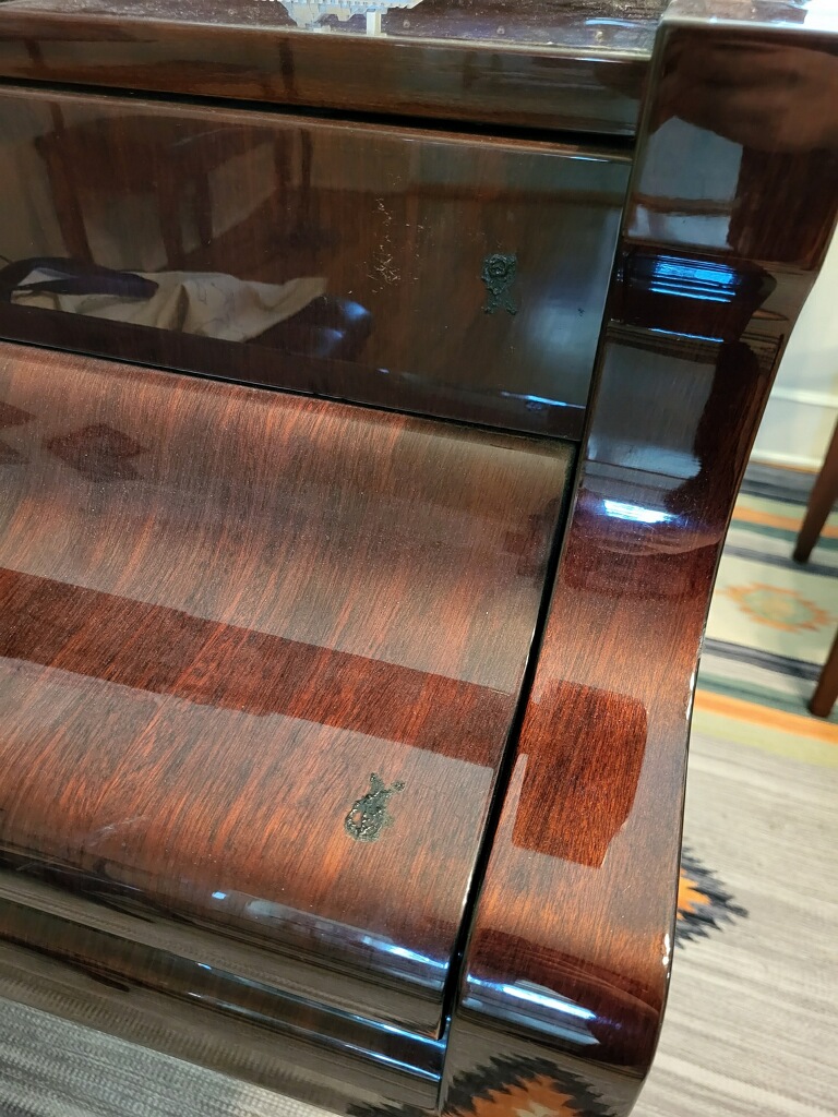 Button on stretcher (top) and melted button residue on fallboard