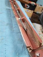 Filed flat with a sharp edge at speaking length