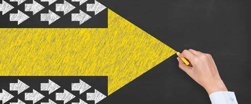 Arrows pointing to the right, one large yellow arrow and several smaller white arrows on a black background, resembling traffic arrows.