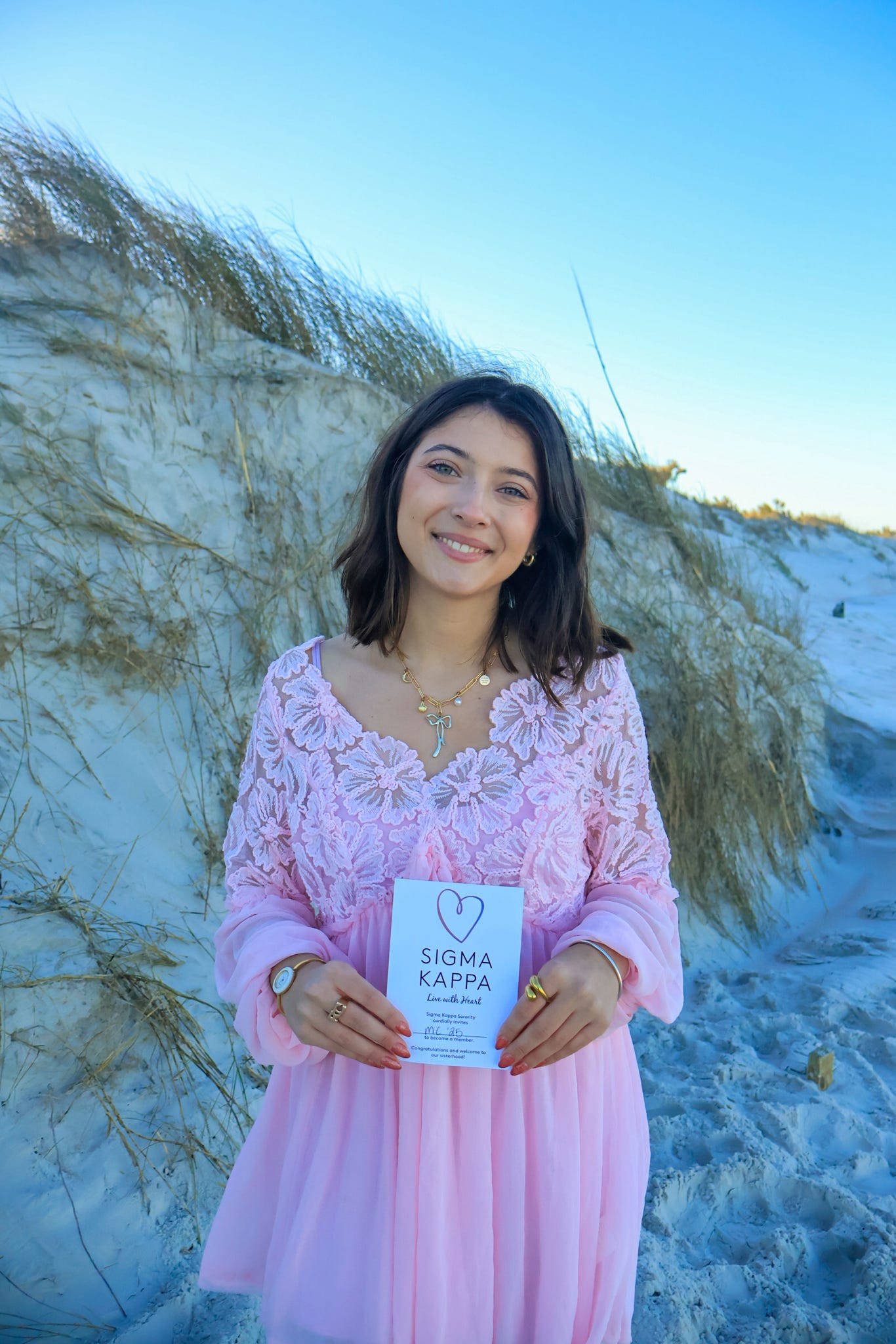 Two members standing confidently with their arms linked