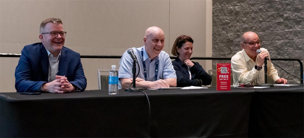 four people sitting at a table