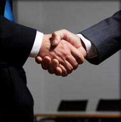 Space Coast Association of REALTORS® Business Partner Development logo Arms of two men in suits shaking hands