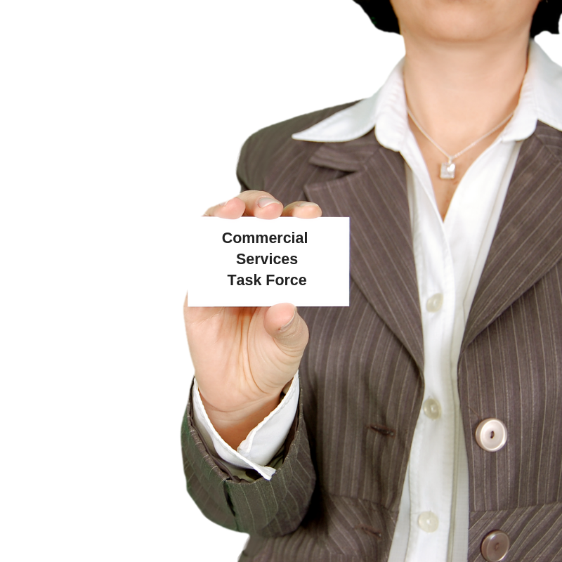 Space Coast Association of REALTORS® Commercial Services Task Force Logo Woman in brown striped suit holding a business card that reads Commercial Services Task Force