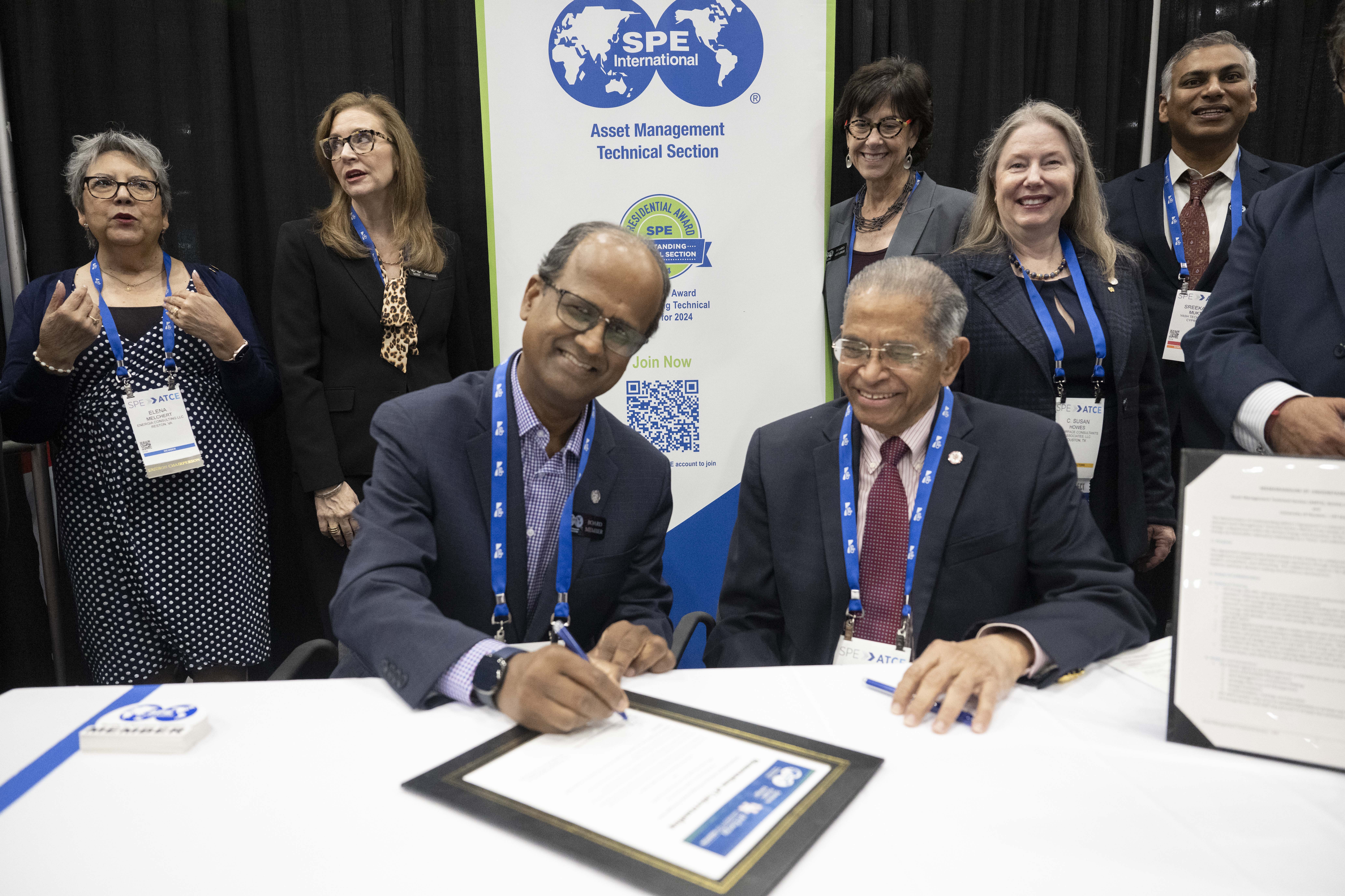 SPE members collaborating in a technical discussion