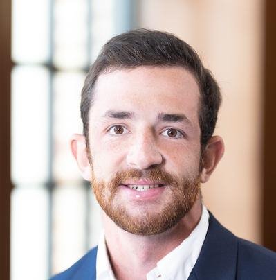 A person in a suit

AI-generated content may be incorrect.