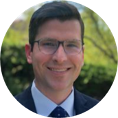 A person wearing glasses and a suit

Description automatically generated with low confidence